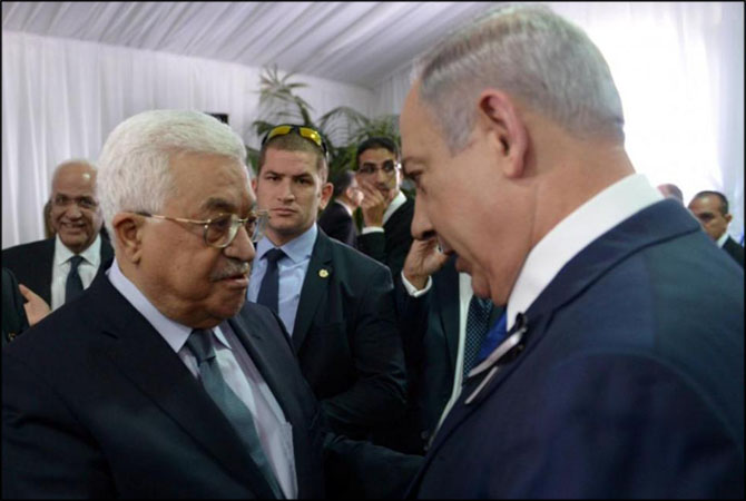 Israeli Prime Minister Benjamin Netanyahu shakes hands with Palestinian President Mahmoud Abbas (L) during the funeral of former Israeli President Shimon Peres. 