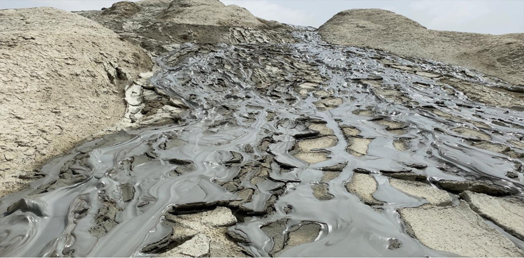 Mud-oozing-out-of-the-volcanic-vent-streaming-down,-drying-and-this-depositing-on-the-mountian