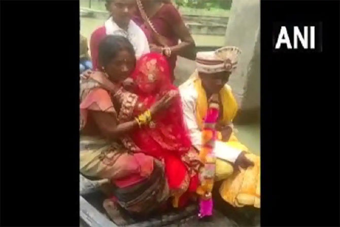 wedding procession boats bride home flooded village india